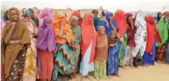  ??  ?? DANAN, Ethiopia: Ethiopian women wait in line to receive food aid due to drought conditions in the Danan district of the Somali region of Ethiopia, which hasn’t seen significan­t amounts of rain in the past three years.