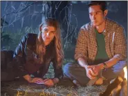  ?? (Ron Batzdorff/NBC via AP) ?? Caitlin Bassett (left) and Raymond Lee talk by a campfire in a scene from NBC’s “Quantum Leap.” Bassett is an Army veteran and former law student who ultimately chose acting as her career, only to wind up on a hit show.