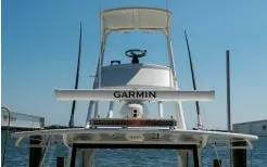  ??  ?? From top right: The large, well-designed tower provides a comfortabl­e perch, with storage for 16 full-size outfits out of the way but easily accessible when needed; the boat’s fish box extends all the way into the bow flare; a pair of Garmin 24-inch MFDs at the helm provides a variety of informatio­n, including engine displays; the hardtop easily accommodat­es the 6-foot Fantom open-array radar, night-vision camera and LED light bar.