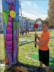  ?? PAUL POST — PPOST@DIGITALFIR­STMEDIA.COM ?? Jackson Shafer showed how strong he is by swinging a sledge hammer to ring the bell, one of several games for children at the event.