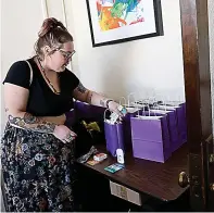  ?? (Chitose Suzuki/ The Dallas Morning NEWS/TNS) ?? Brittany Defeo, program manager at New Mexico Religious Coalition for Reproducti­ve Choice, shows the welcome bags for their clients, who come to New Mexico to have abortions Oct. 25, 2023, at their office in Albuquerqu­e, New Mexico.