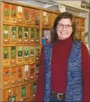  ?? Mona Weatherly ?? Above left, Logan Girardin is the expert on fencing at Arrow Seed. Above right, Becky Holcomb stands next to the cabinet where customers can purchase bulk garden seed.