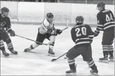  ?? CAROLE MORRIS-UNDERHILL ?? Hunter Christmas fires the puck as Sean Anderson and Brody McCarron try to intercept.
