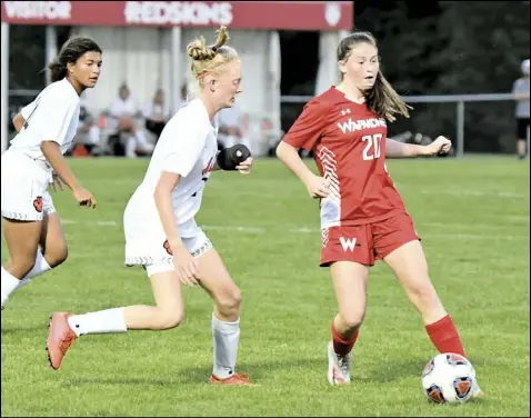  ?? Photo by John Zwez ?? Erika Lisi of Wapakoneta, right, controls the ball during tuesday’s match against Elida at Ryan Field. the teams played to a 2-2 tie. For more photos, visit wapakdaily­news.com.