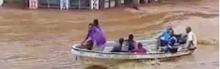  ?? - Courtesy Sanjeet Ram via Reuters ?? INUNDATED: People ride a boat during floods in Ba, Viti Levu, Fiji in this still image taken from a social media video from April 1, 2018.