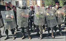  ?? AP ?? Security forces block a street during a protest against a judge investigat­ing last year’s deadly port blast, in Beirut.