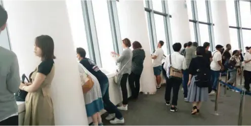  ??  ?? Visitors admire Tokyo from one of the floors at the Skytree