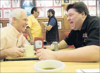  ?? Photograph­s from Cohen Media Group ?? ZIGGY GRUBER , right, is co-owner of Kenny & Ziggy’s delicatess­en in Houston. Seen here displaying his gift of gab with a customer, he’s the central subject of the new documentar­y “Deli Man.”