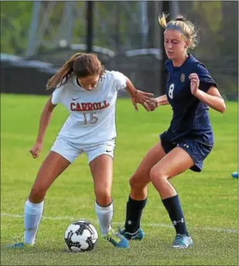  ?? PETE BANNAN — DIGITAL FIRST MEDIA ?? Archbishop Carroll’s Lauren Nigro (15) and Cardinal O’Hara’s Maura Hendrixson (8) battle for control of the ball in the first half of their Catholic League matchup Monday afternoon. Nigro scored the final marker of a four-goal second half in a 2-2 tie.