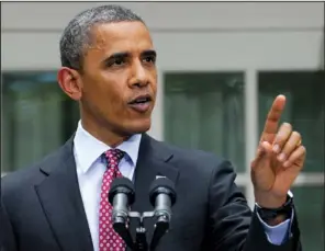  ??  ?? INTERRUPTI­ON: President Barack Obama responds as he is interrupte­d while announcing that his administra­tion will stop deporting and begin granting work permits to younger illegal immigrants who came to the U. S. as children and have since led law- abiding lives on Friday during a statement in the Rose Garden of the White House in Washington.