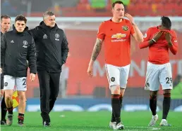  ?? — AFP ?? Manchester United’s Daniel James (from left) manager Ole Gunnar Solskjaer, Phil Jones and Aaron Wan-Bissaka leave the pitch after losing to Burnley 0-2 in their English Premier League match at the Old Trafford in Manchester, north west England, on Wednesday.