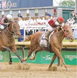  ?? MARK HUMPHREY/AP ?? Rich Strike (21), with Sonny Leon aboard, leads Epicenter down the straightaw­ay to win the 148th running of the Kentucky Derby at Churchill Downs on Saturday in Louisville, Ky. Both horses are scheduled to run at the Preakness Stakes on May 21.