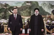  ?? (AP/Xinhua/Yan Yan) ?? Visiting Iranian President Ebrahim Raisi (right) walks with Chinese President Xi Jinping after reviewing an honor guard during a welcome ceremony at the Great Hall of the People in Beijing.