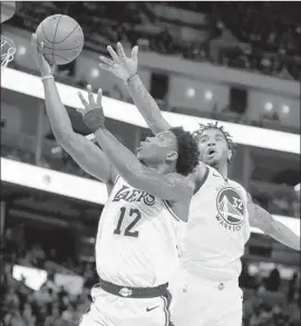  ?? Ben Margot Associated Press ?? DEVONTAE CACOK, one of several young Lakers who played against Marquese Chriss and the Warriors on Friday, scored 16 points with 10 rebounds.