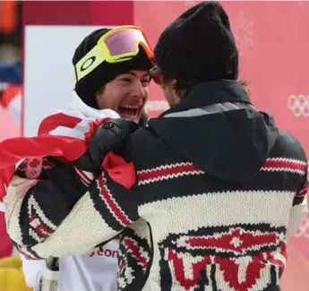  ?? STEVE RUSSELL/TORONTO STAR ?? Canadian snowboarde­r Sebastien Toutant is congratula­ted by a coach after winning the men’s big air competitio­n.