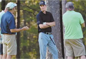  ?? STAFF PHOTO BY CHRIS CHRISTO ?? KEEPING GOOD COMPANY: Tuukka Rask chats with members of his group during the Bruins’ charity golf tournament yesterday at The Internatio­nal in Bolton.