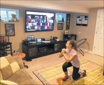  ?? HIGH SCHOOL DISTRICT 228 PHOTOS ?? Oak Forest High School teacher Heather Manzke virtually works out at home while her students join them from their homes.