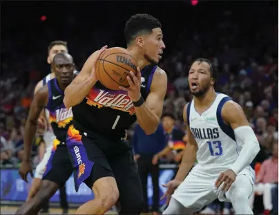  ?? MATT YORK – THE ASSOCIATED PRESS ?? NBA PLAYOFF ROUNDUP
Suns guard Devin Booker, left, who had a team-high 30points. looks to score past Mavericks guard Jalen Brunson on Wednesday.