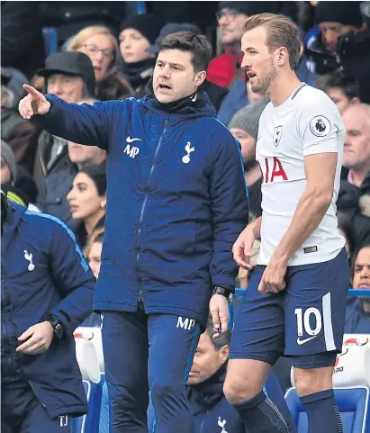  ??  ?? Tottenham manager Mauricio Pochettino, left, speaks with striker Harry Kane during a match last season.