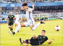  ??  ?? England midfielder Jadon Sancho (11) being tackled by Mexico defender Carlos Robles (3) during their FIFA U-17 World Cup football match in Kolkata on Wednesday