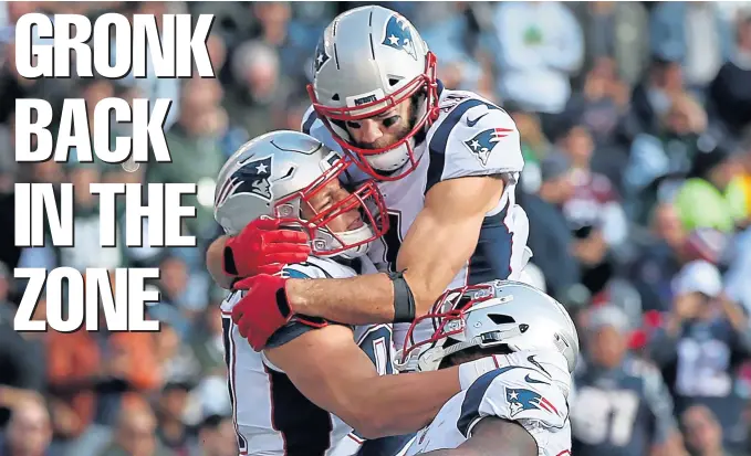  ??  ?? BACK IN THE ZONE: Rob Gronkowski celebrates with Julian Edelman and James White after scoring a touchdown in the first quarter.