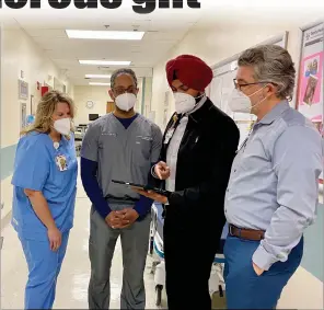  ?? Courtesy photo / Marktwain Medical Center ?? (From left) Stephanie Geuke, Dr. Pardeep Athwal, Charanjit “CJ” Singh and Doug Archer review plans for the new updates coming to the surgery center at Marktwain Medical Center in San Andreas.