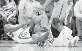  ?? Pat Sullivan / Associated Press ?? Dwight Howard, right, feels the pain after colliding with Ty Lawson and suffering a sprained ankle Wednesday night.