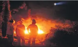  ?? Francisco Villeda AFP/Getty Images ?? FIREFIGHTE­RS at the scene of the blaze. Siphoning gasoline has become commonplac­e across Mexico’s villages and rural areas, where poverty is widespread.