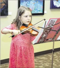  ?? PHOTOS BY MIKE PARKER / PFLUGERVIL­LE PFLAG ?? Emlyn, 5, plays violin during the Toddler Talent Show at the Pflugervil­le Public Library.