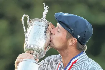  ?? GETTY IMAGES ?? Sweet success . . . American Bryson DeChambeau kisses the championsh­ip trophy after winning the US Open at Winged Foot New York yesterday.