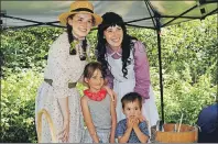  ?? MAUREEN COULTER/THE GUARDIAN ?? Dominique LeBlanc, left, as Anne Shirley, and Emily Proude, as Diana Barry, pose for a photo with Elena MacNevin, 5, and Caleb MacNevin, 3, at the 100th anniversar­y of Canada’s national historic sites at Green Gables Heritage Place in Cavendish on...
