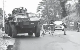  ?? (Froilan Gallardo/ Rappler photo) ?? Army soldiers use tanks at a checkpoint in Pantar town, Lanao del Norte to prevent flying voters from traveling to Lanao del Sur on Monday, May 9.