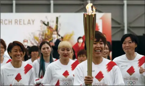  ??  ?? Members of the Japanese women’s soccer team are shown as they begin the Olympic torch relay in the Fukasima prefecture on Thursday. The opening ceremonies of the games are scheduled for July 23 after being postponed due to the COVID-19 pandemic.