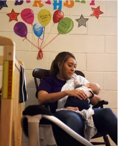  ??  ?? A worker cradles an infant at the Monahans Bright Stars day-care centre in Monahans, Texas on Aug 21. — WP-Bloomberg photos by Callaghan O’Hare