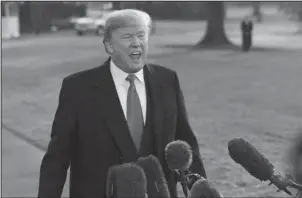  ?? The Associated Press ?? LAND GRAB: President Donald Trump speaks to reporters before boarding Marine One on the South Lawn of the White House in Washington, Monday, Dec. 4, before heading to Utah. Trump will be announcing plans to scale back two sprawling national monuments...