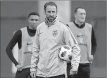  ?? DMITRI LOVETSKY/AP PHOTO ?? England head coach Gareth Southgate, center, attends official training under rain on Wednesday in Zelenogors­k, Russia.