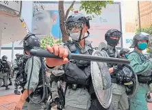  ??  ?? Riot police in the Central district, Hong Kong, in May.