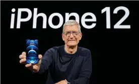  ??  ?? Apple’s chief executive, Tim Cook, with the new iPhone 12 Pro. Photograph: Brooks Kraft/ Apple/EPA