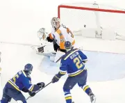  ?? AP ?? The Blues’ Robby Fabbri, bottom left, scores past Flyers goalie Steve Mason.