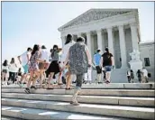  ?? CHIP SOMODEVILL­A/GETTY ?? Visitors wait at the Supreme Court on Monday. There is still a pending case on North Carolina’s election map.