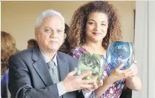  ?? NICK BRANCACCIO ?? Oday Al-Taie and Jill Thompson hold their Volunteers Changing Lives Awards from the United Way/Centraide Windsor-Essex County at the Ambassador Golf Club on Tuesday.