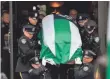  ?? JEWEL SAMAD, AFP/GETTY IMAGES ?? Officers carry the casket of Wenjian Liu after his funeral Sunday in Brooklyn. Thousands stood in the area to honor him.
