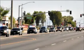  ?? PHOTO TOM BODUS ?? Law enforcemen­t agencies from throughout the Valley were represente­d in the procession that carried ECPD Officer Efren Coronel’s body from San Diego to the funeral home in Brawley.