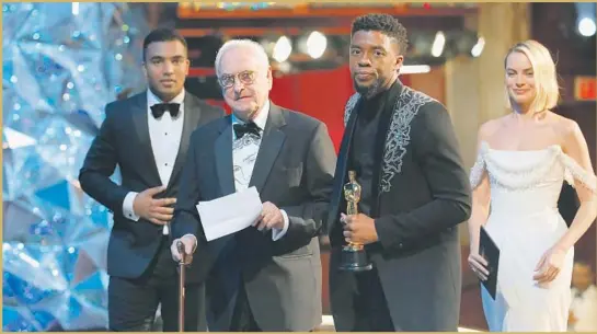  ?? Al Seib Los Angeles Times ?? JAMES IVORY (with his speech), adapted screenplay winner for “Call Me by Your Name,” with presenters Chadwick Boseman (with award) and Margot Robbie.