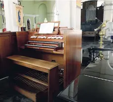  ??  ?? The console (foreground) and some of the pipes of the Kingston Parish Church’s pipe organ.