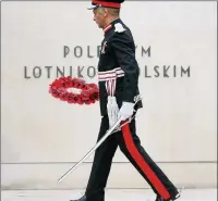  ??  ?? n REMEMBRANC­E: Ken Olisa laying a wreath. Left, Lowering the Standards as the last post is called
Photos by Rob Bourne www.buyaphotot­ms.co.uk WL154919