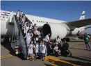  ?? (Marc Israel Sellem/The Jerusalem Post) ?? NEW IMMIGRANTS from France disembark at Ben-Gurion Airport yesterday.