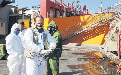  ?? AFP ?? Jordanian forensics experts inspect the site of a toxic gas explosion at the Red Sea port of Aqaba on Tuesday.