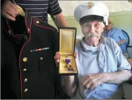  ??  ?? In addition to the complete U.S. Marines dress blues uniform, Korean War veteran Normand Dupras received his Purple Heart and National Defense medals.