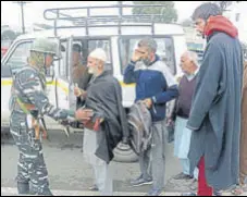  ?? PTI ?? A securityma­n frisks passengers of a private vehicle during a high alert in Srinagar on Monday.